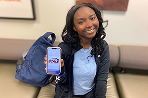  Andrea Burns showing the logo she designed during her internship at Scott Clark Toyota